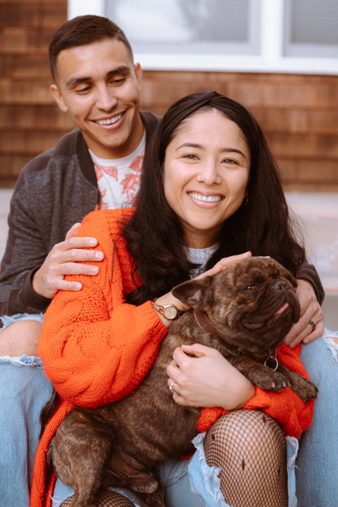 Couple sitting with their french bull dog