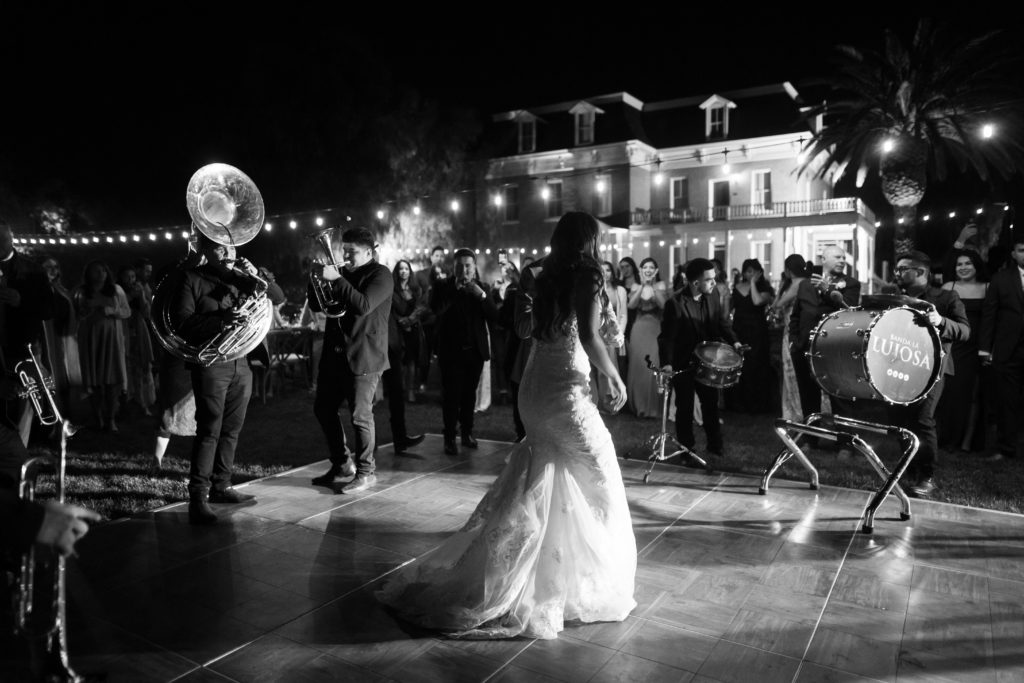 bride and groom surrounded by a Banda during the reception
