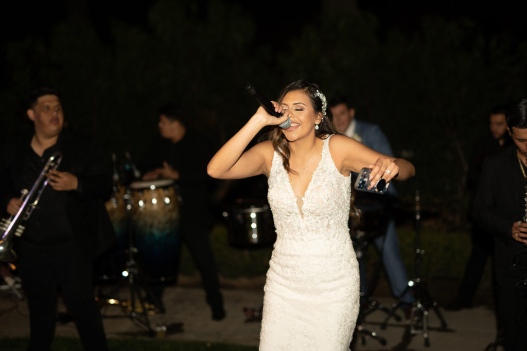 bride singing mariachi at her wedding reception