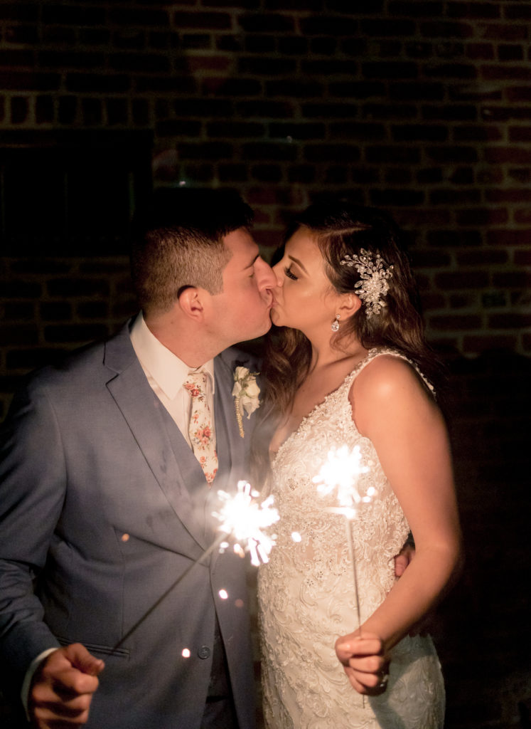 bride and groom holding sparkler