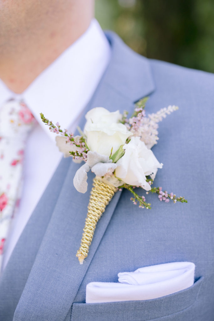 white and pink grooms boutonniere
