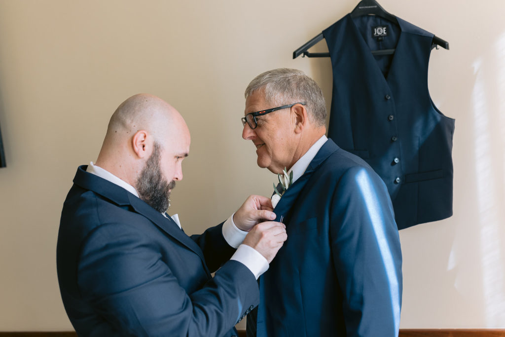 groom adjusting father's tie