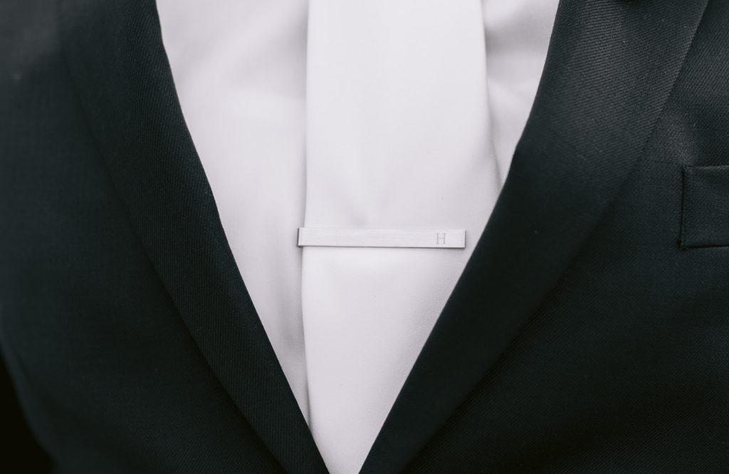 detail shot of groom's tie clip
