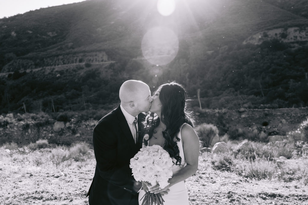 bride and groom mountain wedding kiss