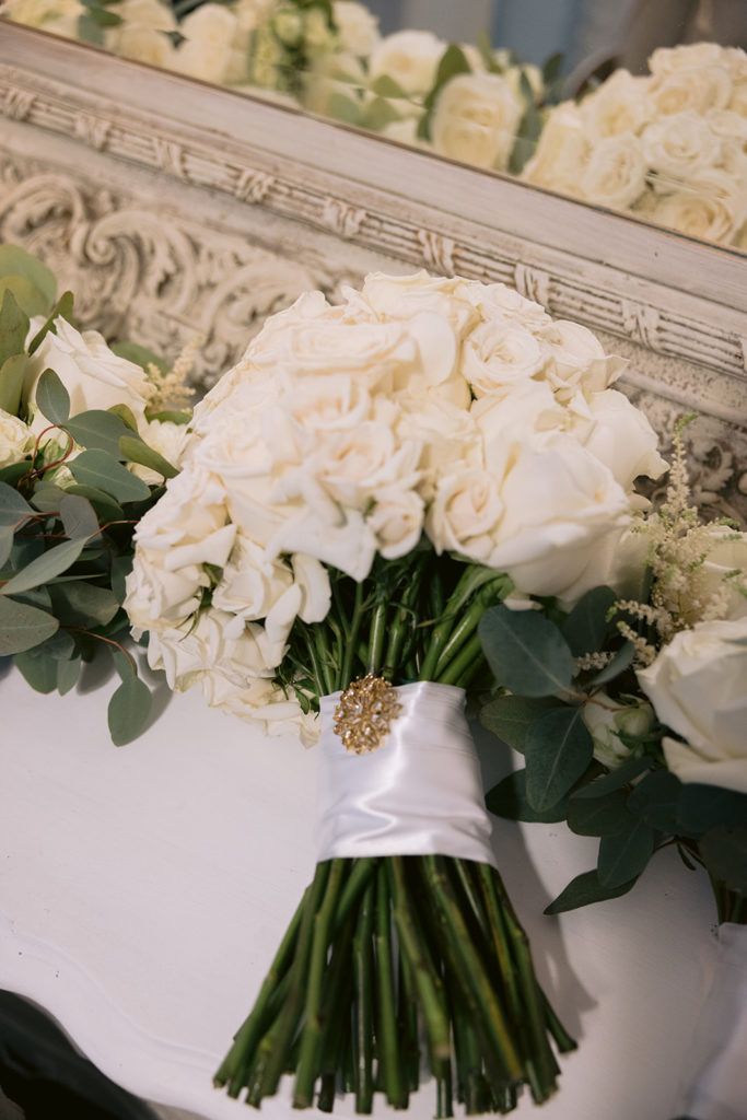 detail shot of bride's white roses bouquet