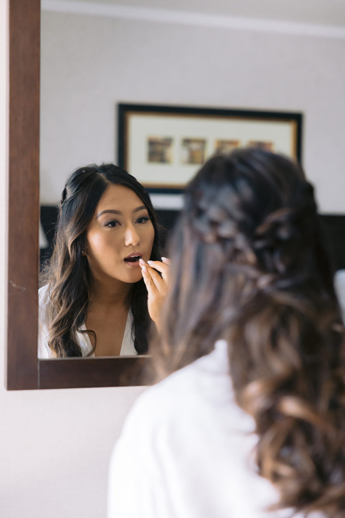 bride getting ready and makeup touch up