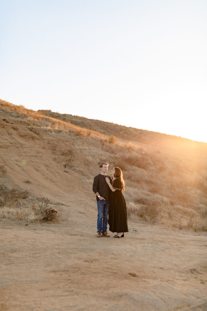 riverside engagement session with couple far away in the frame